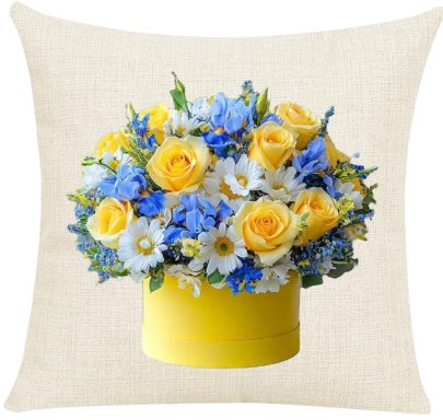 Yellow Roses Pillow Cover Yellow roses and blue flowers arranged in a round yellow container.